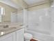 Clean, tiled bathroom featuring a shower-tub combo and modern sink vanity at 3954 Springleaf Pt, Stone Mountain, GA 30083