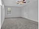 Well-lit carpeted bedroom with a ceiling fan and a window with wood blinds at 3954 Springleaf Pt, Stone Mountain, GA 30083