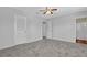 Bright bedroom featuring a ceiling fan, plush carpet, and easy bathroom access at 3954 Springleaf Pt, Stone Mountain, GA 30083