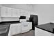 Kitchen area offering white cabinets, black countertops, and modern appliances at 3954 Springleaf Pt, Stone Mountain, GA 30083