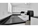Modern kitchen featuring black countertops, ample cabinets, and an island at 3954 Springleaf Pt, Stone Mountain, GA 30083