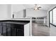 Open concept kitchen with black countertops and grey wood floor at 3954 Springleaf Pt, Stone Mountain, GA 30083