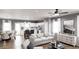 Open concept living room with modern furnishings, hardwood floors, lots of natural light, and a view of the kitchen at 40 Alameda St # 131, Loganville, GA 30052