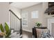 Entryway staircase has dark wood and white trim, next to a bright, plant-filled living space at 2046 Drew Dr, Atlanta, GA 30318