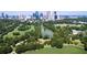 Aerial view of Piedmont Park with lush greenery, a pond, and the Atlanta skyline at 405 9Th Ne St, Atlanta, GA 30309