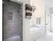 Bathroom featuring a glass shower, soaking tub, and modern towel rack at 405 9Th Ne St, Atlanta, GA 30309