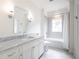 This bright bathroom features a combination shower and tub, a large vanity with chrome hardware, and tile flooring at 405 9Th Ne St, Atlanta, GA 30309