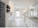 Spacious bathroom featuring marble floors, double vanity, soaking tub, and glass shower at 405 9Th Ne St, Atlanta, GA 30309