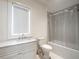 Clean bathroom featuring a shower and tub combo, vanity with marble countertop, and natural light at 405 9Th Ne St, Atlanta, GA 30309