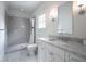 This bathroom has a sleek shower with gray tile, a window for natural light, and a spacious vanity with modern fixtures at 405 9Th Ne St, Atlanta, GA 30309