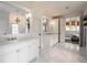 Bright bathroom with marble floors, double vanity, and an open view to the Primary bedroom at 405 9Th Ne St, Atlanta, GA 30309
