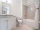 Clean bathroom with a shower-tub combo, modern vanity, and neutral color scheme at 405 9Th Ne St, Atlanta, GA 30309