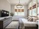 Spacious bedroom featuring a dresser, rug, modern chandelier, and multiple windows with natural light at 405 9Th Ne St, Atlanta, GA 30309