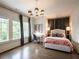 Bedroom with lots of natural light, featuring hardwood floors, large windows, and a stylish light fixture at 405 9Th Ne St, Atlanta, GA 30309