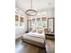 Bedroom featuring tall windows, modern lighting, and sleek furniture at 405 9Th Ne St, Atlanta, GA 30309