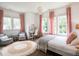 Bright bedroom features a chandelier, large windows, and natural decor, creating a relaxing and inviting atmosphere at 405 9Th Ne St, Atlanta, GA 30309