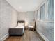 Charming bedroom featuring patterned wallpaper, a cozy daybed, and a classic armchair at 405 9Th Ne St, Atlanta, GA 30309