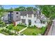 Elegant two-story home with a manicured lawn, white fence, and beautiful landscaping at 405 9Th Ne St, Atlanta, GA 30309