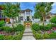Charming white home featuring a landscaped front yard, wooden gate, and manicured bushes at 405 9Th Ne St, Atlanta, GA 30309
