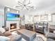 Spacious living room featuring a fireplace, modern lighting, and a view into the kitchen at 405 9Th Ne St, Atlanta, GA 30309