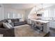 Cozy living room and kitchen combo featuring an area rug, sofa, and modern pendant lighting at 405 9Th Ne St, Atlanta, GA 30309