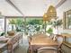 Inviting outdoor dining area with wicker pendant lights and a view of the sparkling pool and landscaped backyard at 405 9Th Ne St, Atlanta, GA 30309
