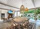 Covered outdoor dining area overlooking a pool, complete with comfortable seating, fireplace, and elegant décor at 405 9Th Ne St, Atlanta, GA 30309