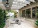 Charming outdoor patio with stone flooring, a glass roof, cozy seating, and verdant surroundings at 405 9Th Ne St, Atlanta, GA 30309