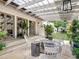 Inviting covered patio featuring stone floors, a glass ceiling, elegant furniture, and lush landscaping at 405 9Th Ne St, Atlanta, GA 30309