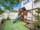 Backyard with play structure featuring a slide and swings, nestled in a neatly landscaped area at 405 9Th Ne St, Atlanta, GA 30309