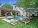 Beautiful pool area with lounge chairs and umbrellas, set in a serene backyard with manicured landscaping at 405 9Th Ne St, Atlanta, GA 30309