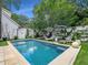 Inviting pool area featuring lounge chairs and lush greenery, perfect for outdoor relaxation and entertaining at 405 9Th Ne St, Atlanta, GA 30309