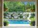 Relaxing pool area with lounge seating and lush landscaping, offering a private backyard oasis at 405 9Th Ne St, Atlanta, GA 30309