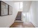 Elegant staircase featuring hardwood floors, carpet runner, and stylish wall decor at 405 9Th Ne St, Atlanta, GA 30309
