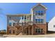 Two-story home with wood deck and stairs leading to the backyard, brick foundation, and many windows offering natural light at 6040 Ashborough Park, Cumming, GA 30040