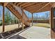 Backyard view showcasing an outdoor patio and stairs leading to an upper deck and landscaped yard at 6040 Ashborough Park, Cumming, GA 30040