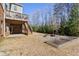Spacious backyard featuring a fire pit, garden beds, and a multi-level deck, perfect for outdoor activities at 6040 Ashborough Park, Cumming, GA 30040