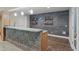 Basement bar area with a stone facade, open shelving, and modern fixtures, perfect for entertaining at 6040 Ashborough Park, Cumming, GA 30040