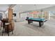 Finished basement showcasing a pool table and bar, complemented by a large seating area at 6040 Ashborough Park, Cumming, GA 30040