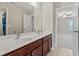 This bathroom features double sinks with a clear view into the well-lit bedroom through an open door at 6040 Ashborough Park, Cumming, GA 30040