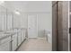 Bright bathroom featuring tiled floors, white cabinets, granite countertops and glass enclosed shower at 6040 Ashborough Park, Cumming, GA 30040