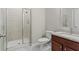 Bathroom featuring neutral walls, a walk-in shower, a toilet, and vanity sink at 6040 Ashborough Park, Cumming, GA 30040