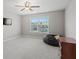 Bedroom with light-colored carpet, neutral walls, ceiling fan, and good natural lighting at 6040 Ashborough Park, Cumming, GA 30040