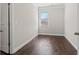 An empty bedroom features hardwood floors, natural lighting and neutral paint at 6040 Ashborough Park, Cumming, GA 30040