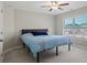 Bedroom featuring a bed, ceiling fan, and a window, offering a comfortable and relaxing atmosphere at 6040 Ashborough Park, Cumming, GA 30040