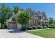 Beautiful two-story home featuring a three car garage and meticulously maintained landscaping at 6040 Ashborough Park, Cumming, GA 30040