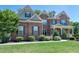Charming two-story brick home with manicured lawn and inviting front porch at 6040 Ashborough Park, Cumming, GA 30040