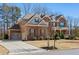 Beautiful brick home featuring a spacious driveway, two-car garage and manicured lawn at 6040 Ashborough Park, Cumming, GA 30040