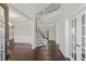 Elegant foyer showcasing hardwood floors, staircase, and bright, neutral walls at 6040 Ashborough Park, Cumming, GA 30040