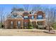 Charming two-story brick home with a cozy front porch and well-manicured landscaping at 6040 Ashborough Park, Cumming, GA 30040